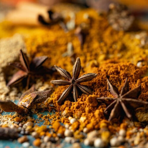 Close-up of essential oil-enriched star anise powder, revealing its deep brown color and finely textured appearance