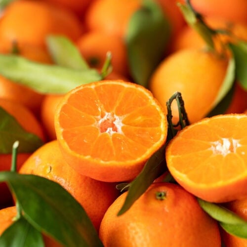 Close-up of essential oil-enriched tangerine, highlighting its vibrant orange color and textured peel
