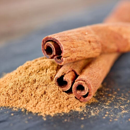 Close-up view of aromatic cinnamon sticks, revealing their rich texture, warm brown hues, and enticing scent.