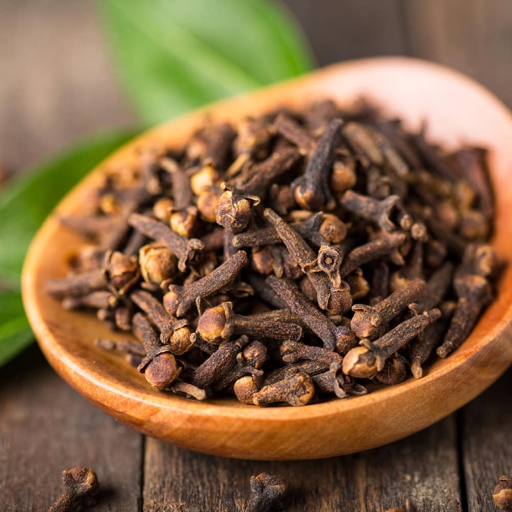 Macro shot of aromatic clove buds, revealing their rich brown tones and unique, textured appearance