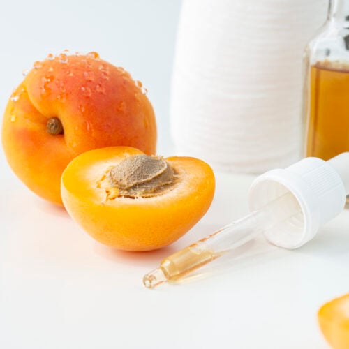 Apricot kernel oil on the white background.
