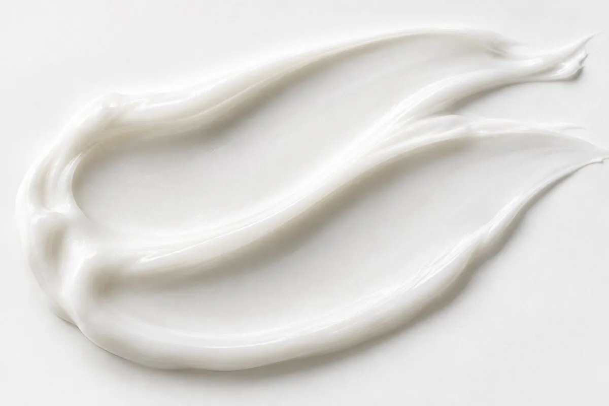 Close-up of smooth white lotion with soft silky folds